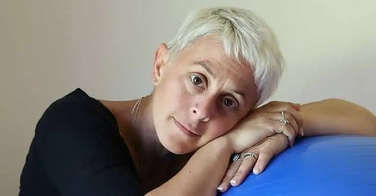 Alison Ogier, birth and postnatal doula, resting against a birth ball